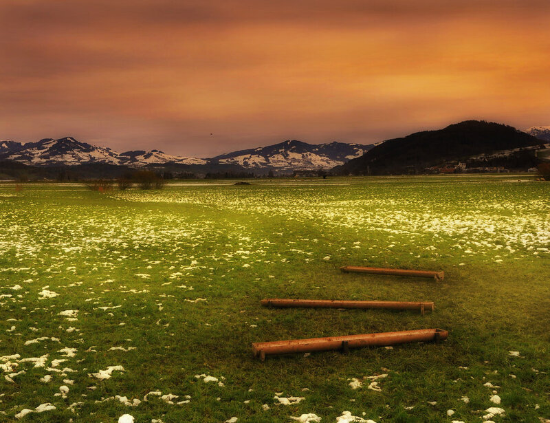 Snow-dusted Field with Mountains