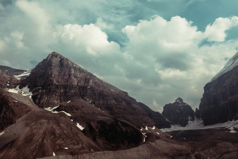 Snow-dusted Mountain Peaks — Brown