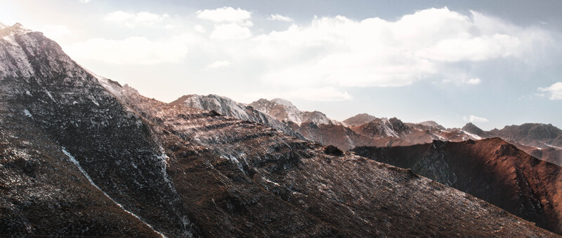 Snow-dusted Mountain Range — Brown, Serene