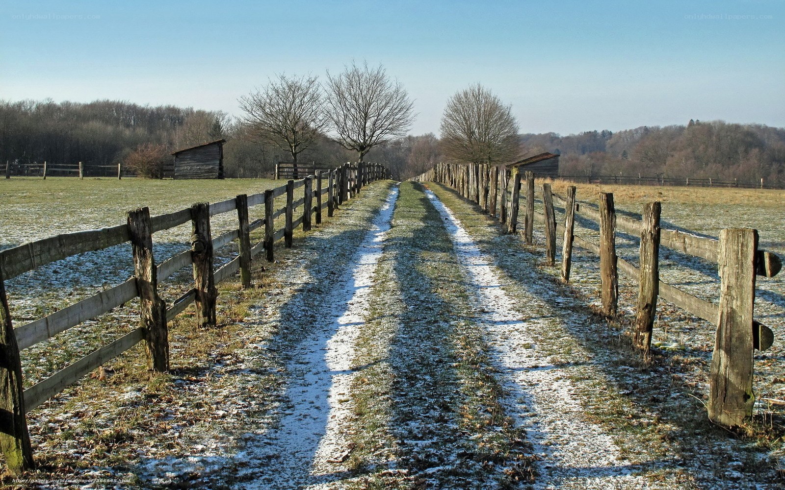 Snow-dusted path in rural landscape