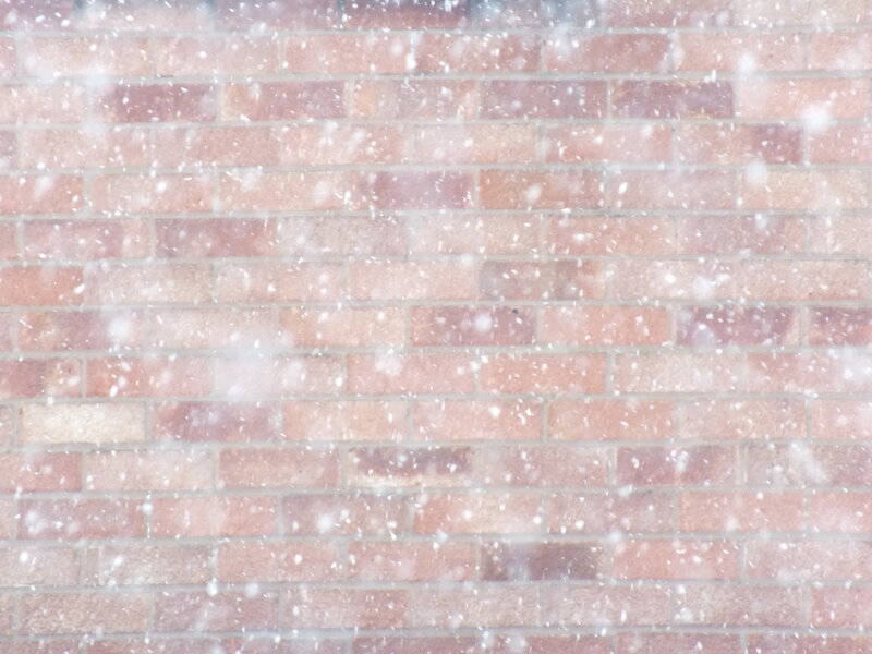 Snow Falling on Brick Wall