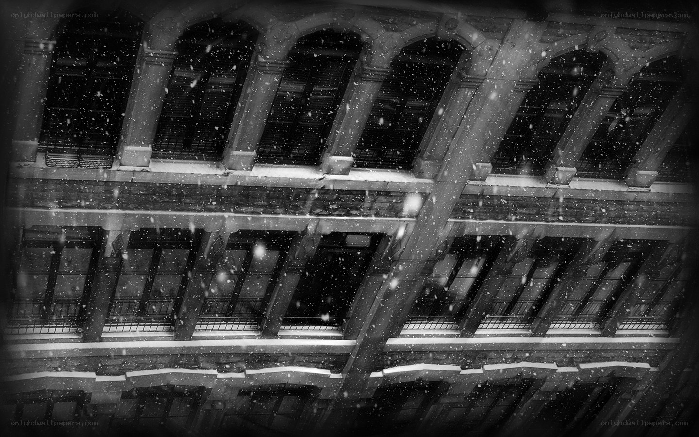 Snow falling on old building