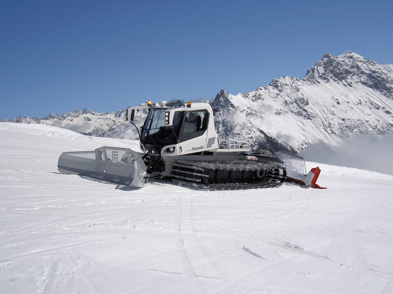 Snow groomer on a mountain slope