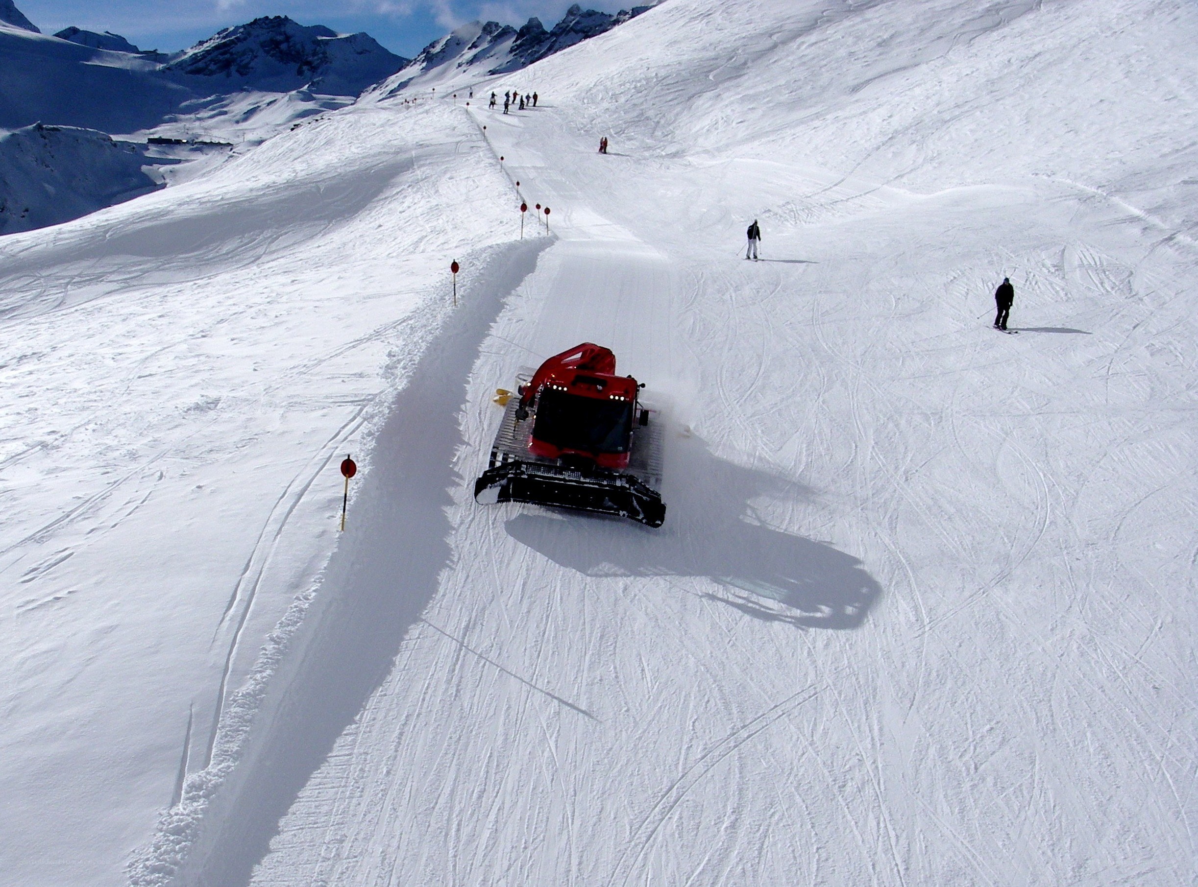 Snow groomer on ski slope