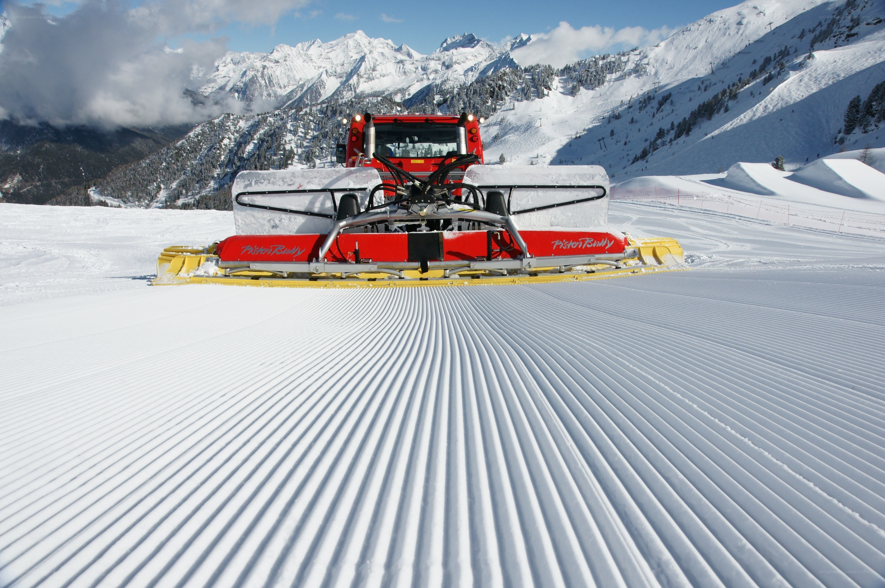 Snow grooming machine on a ski slope