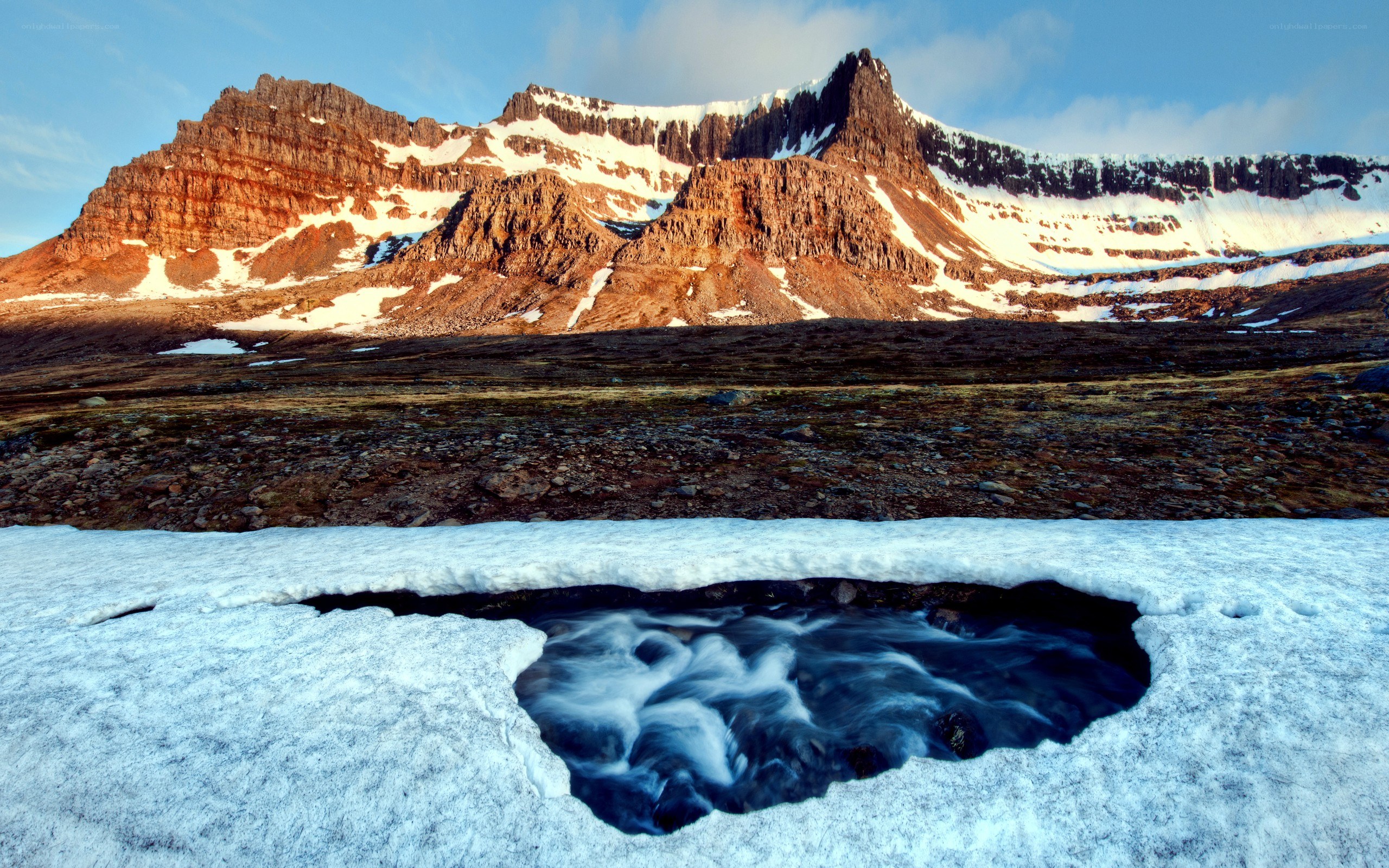 Snow melt stream in mountain landscape