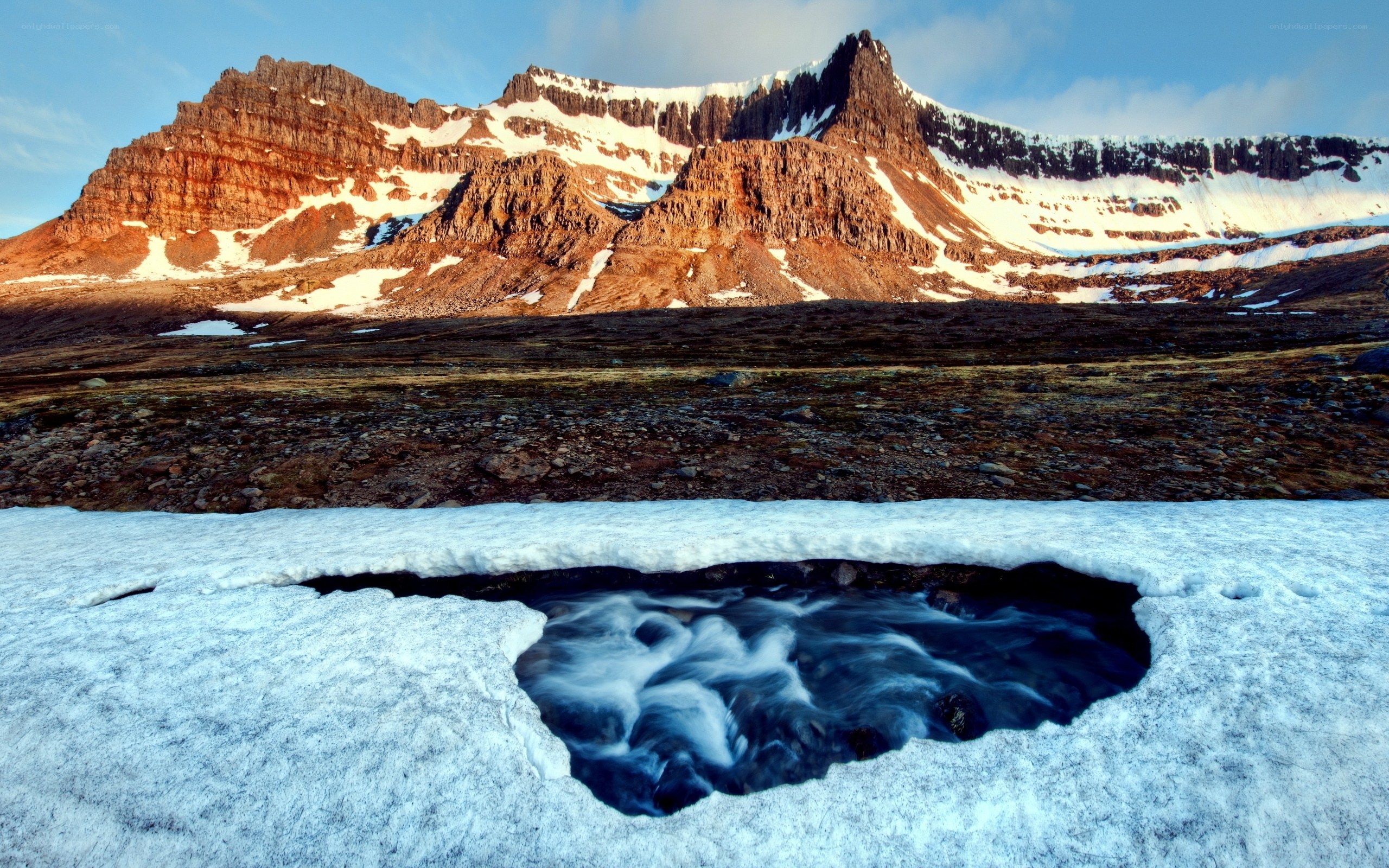 Snow melt stream in mountain landscape