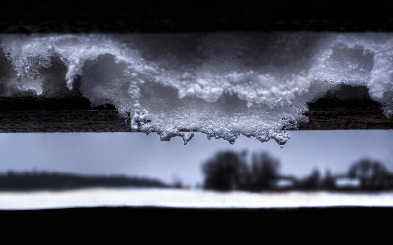 snow melting on wooden beam