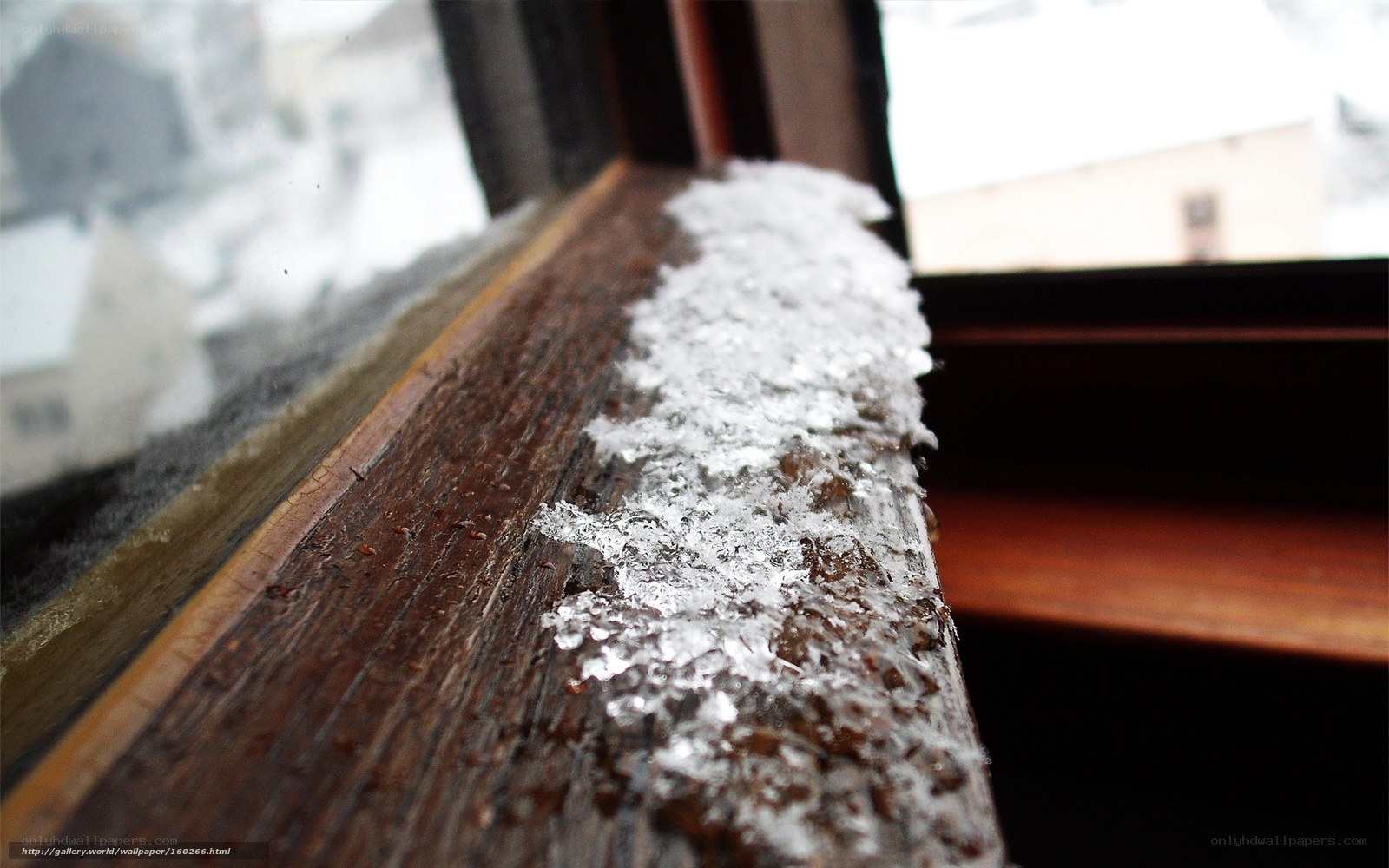 snow on a wooden windowsill