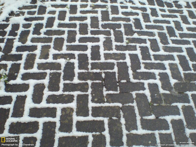 Snow on cobblestone pavement