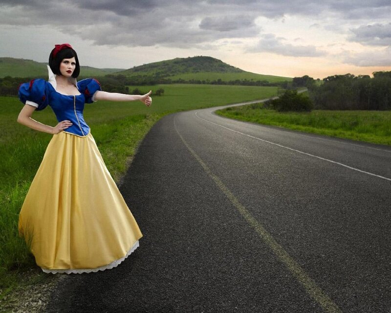 Snow White hitchhiking on a road