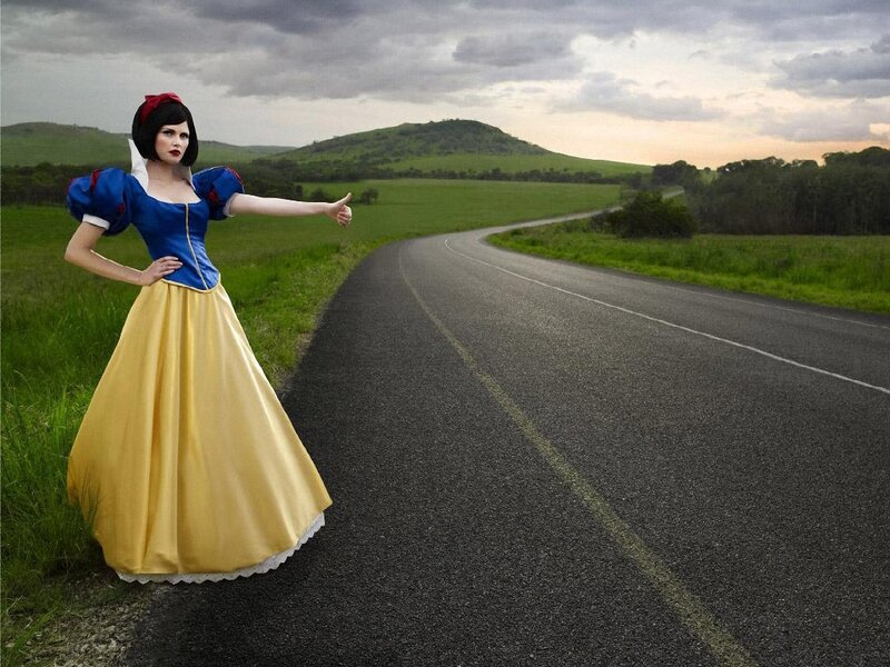 Snow White hitchhiking on a road