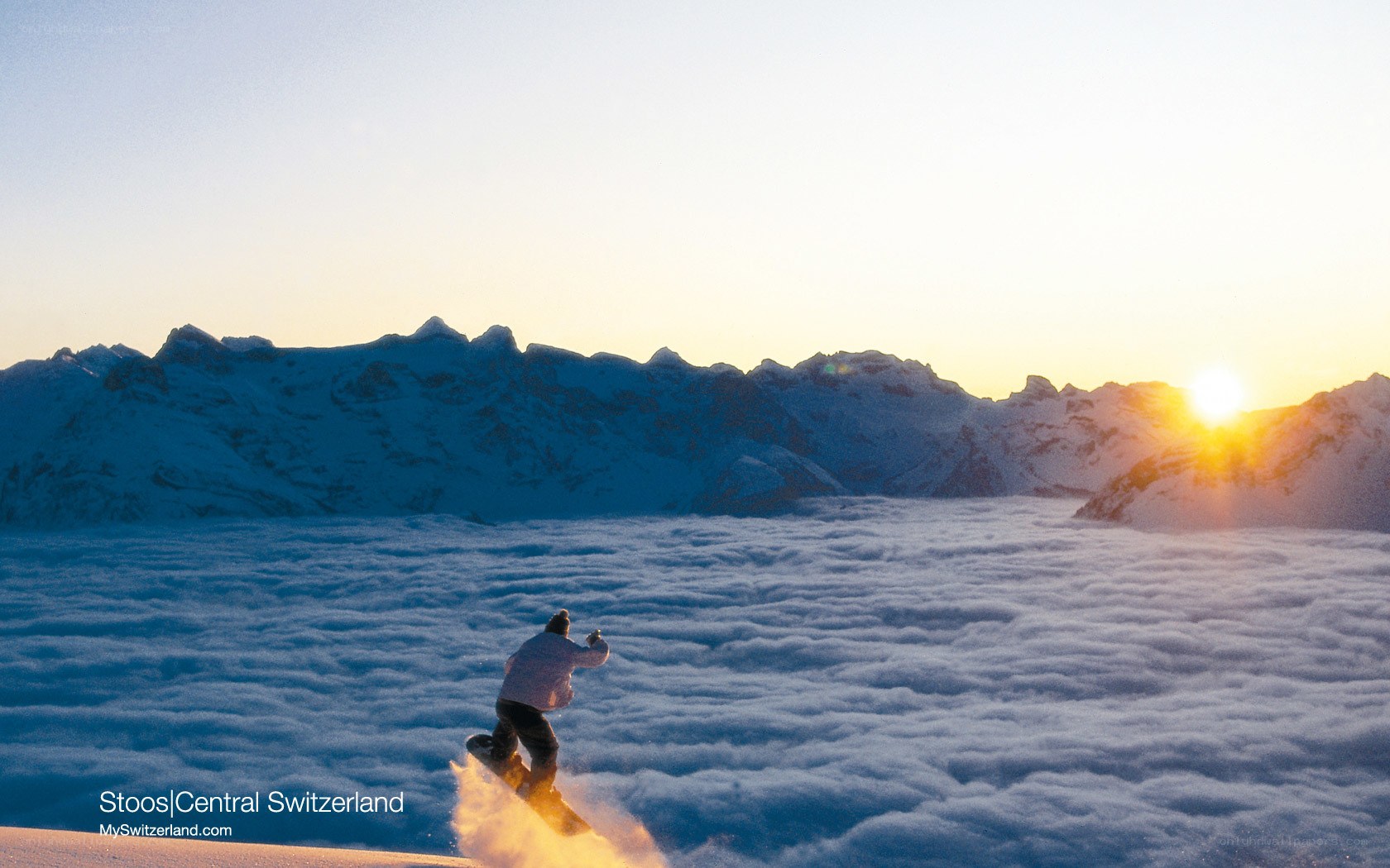 Snowboarder above the clouds