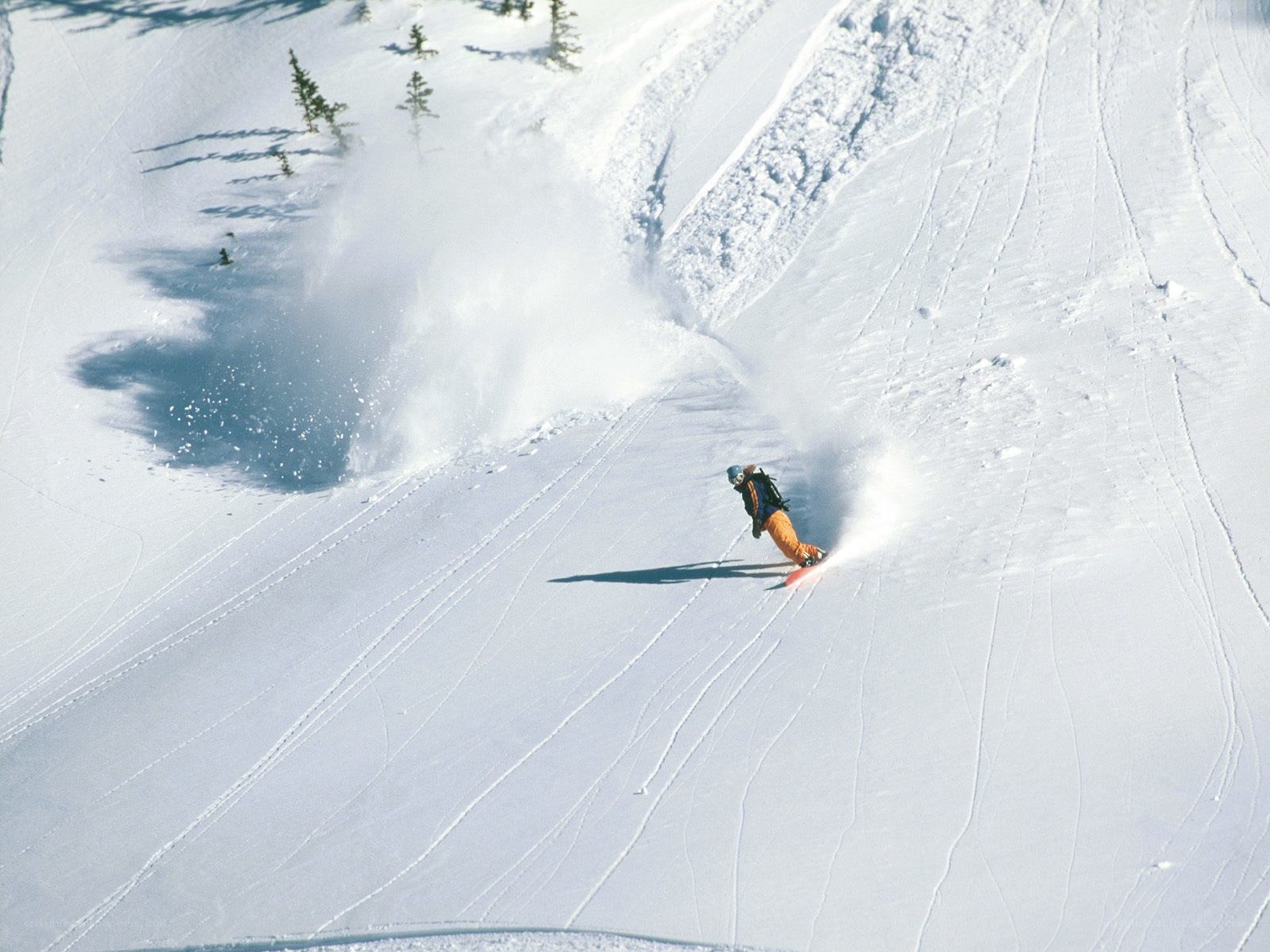 Snowboarder carving down a slope