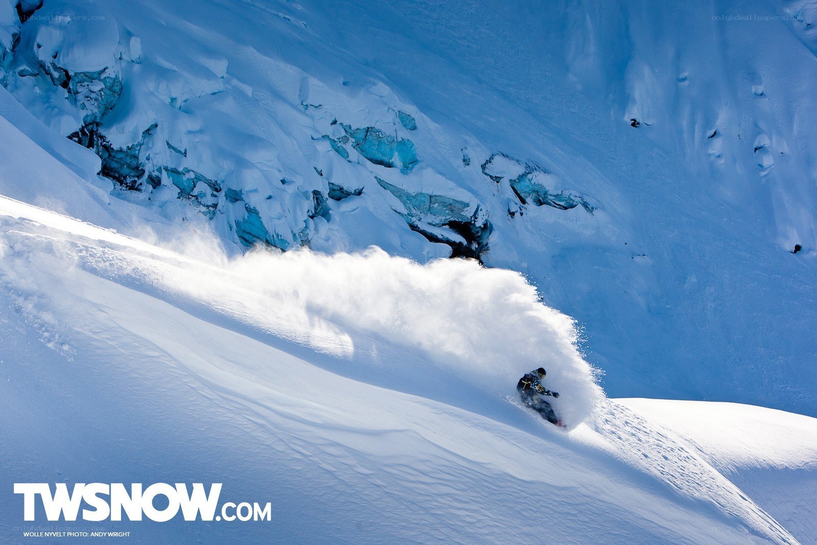 Snowboarder carving down mountain