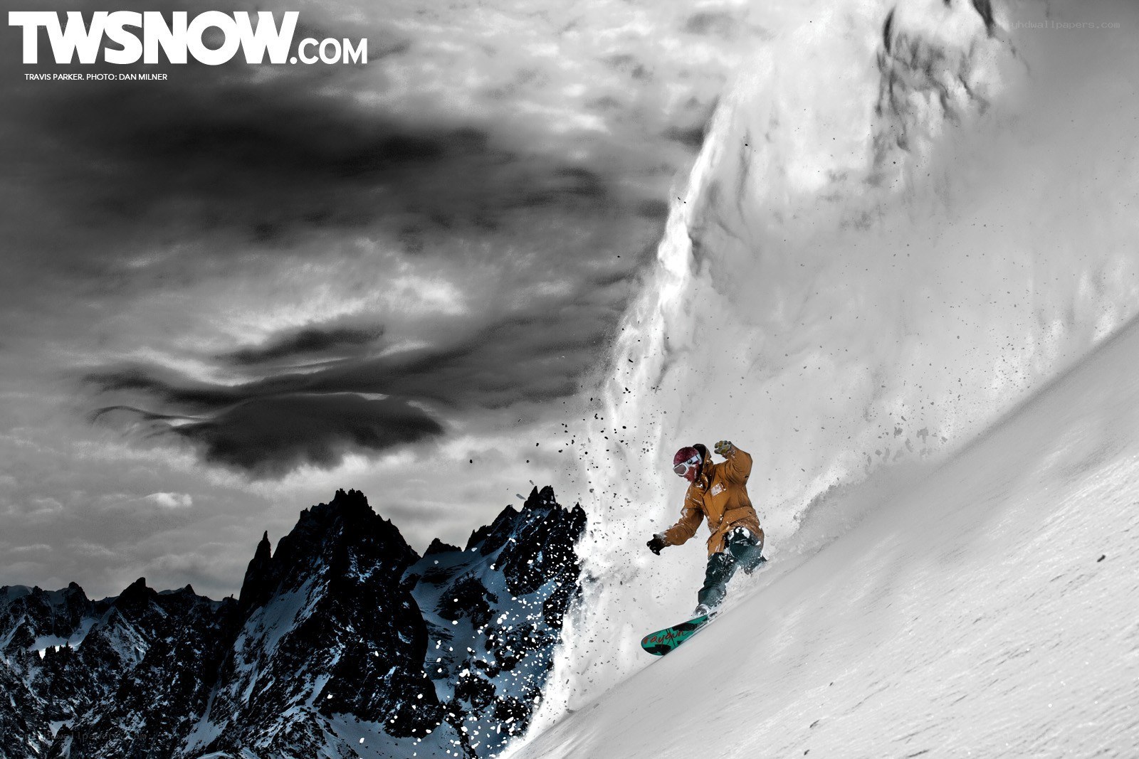 Snowboarder carving down mountain