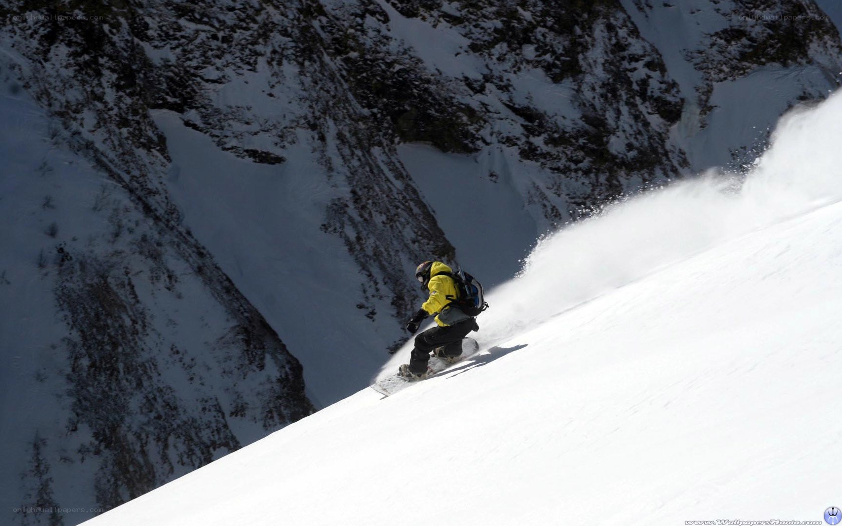 Snowboarder carving down mountain