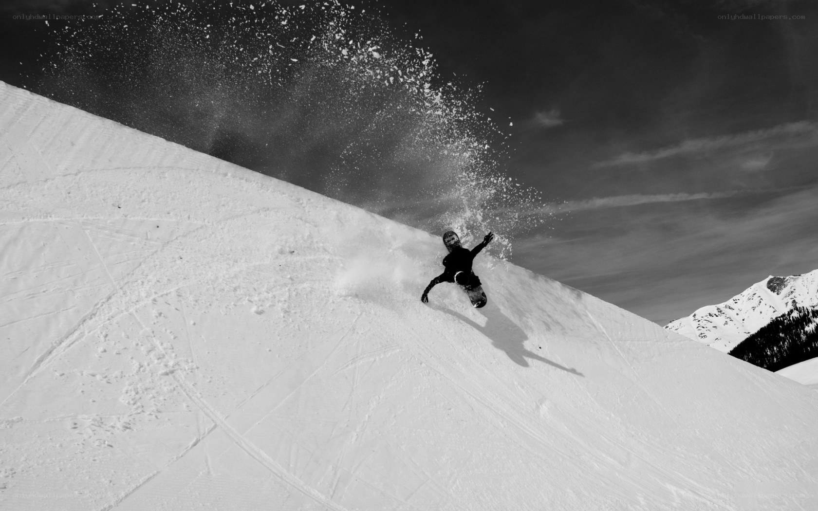 Snowboarder carving down slope