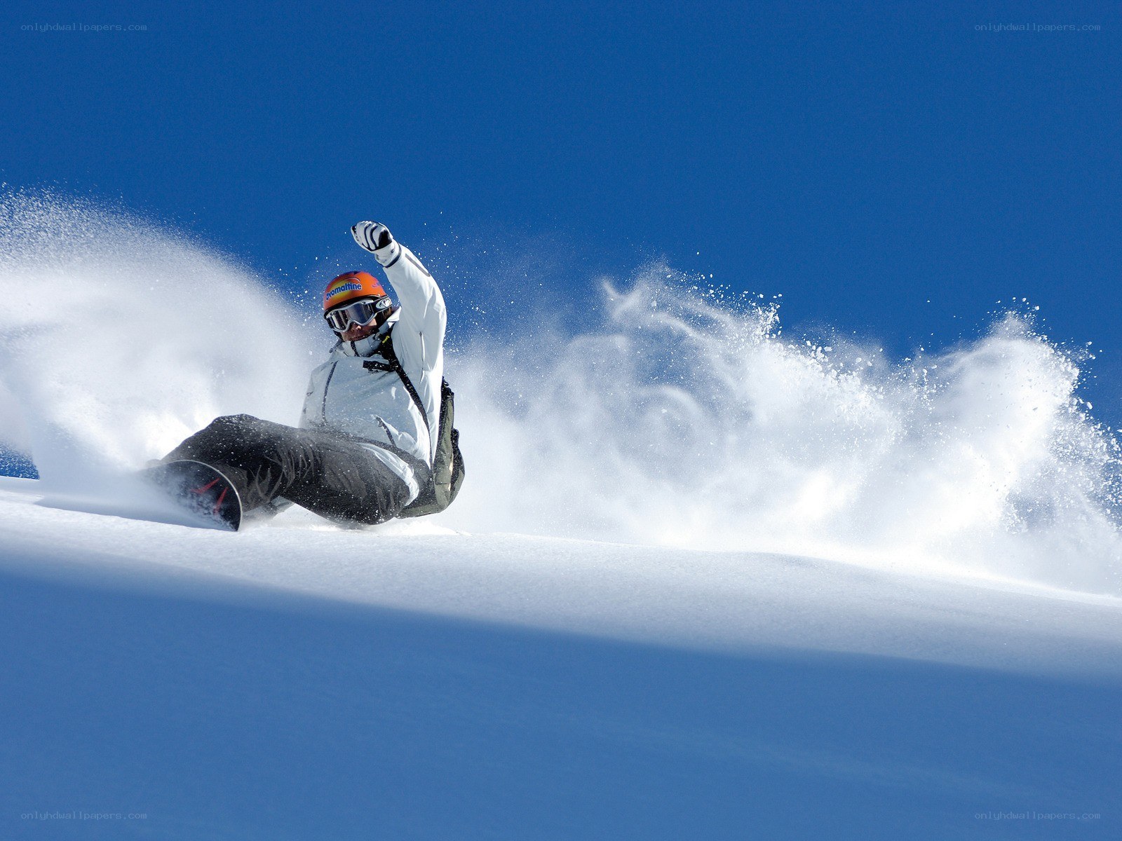 Snowboarder carving down slope