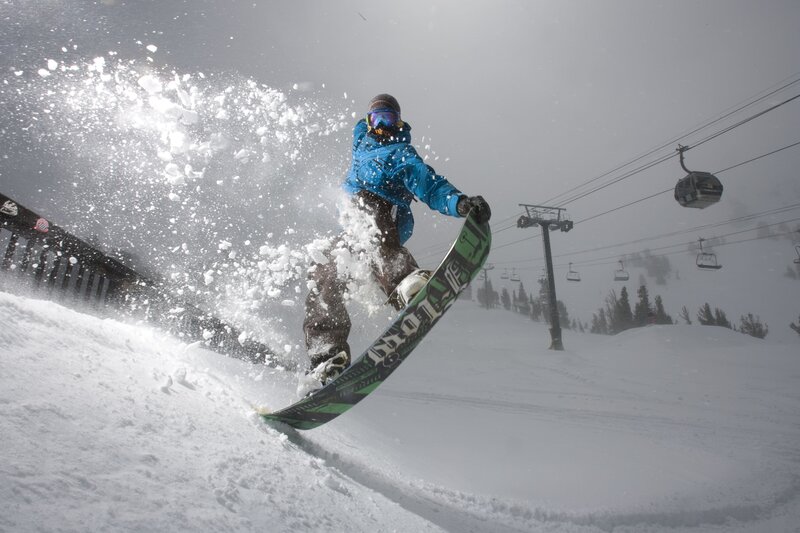 Snowboarder carving on a snowy slope