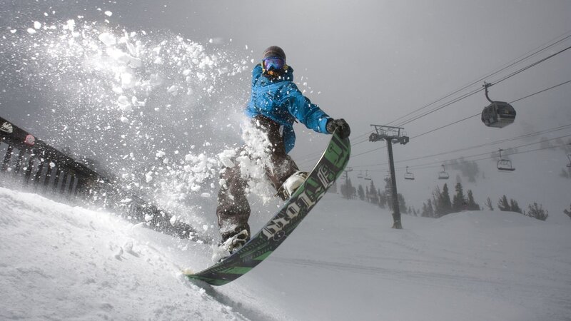 Snowboarder carving on a snowy slope