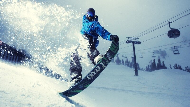 Snowboarder carving on a snowy slope