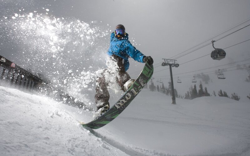 Snowboarder carving on a snowy slope