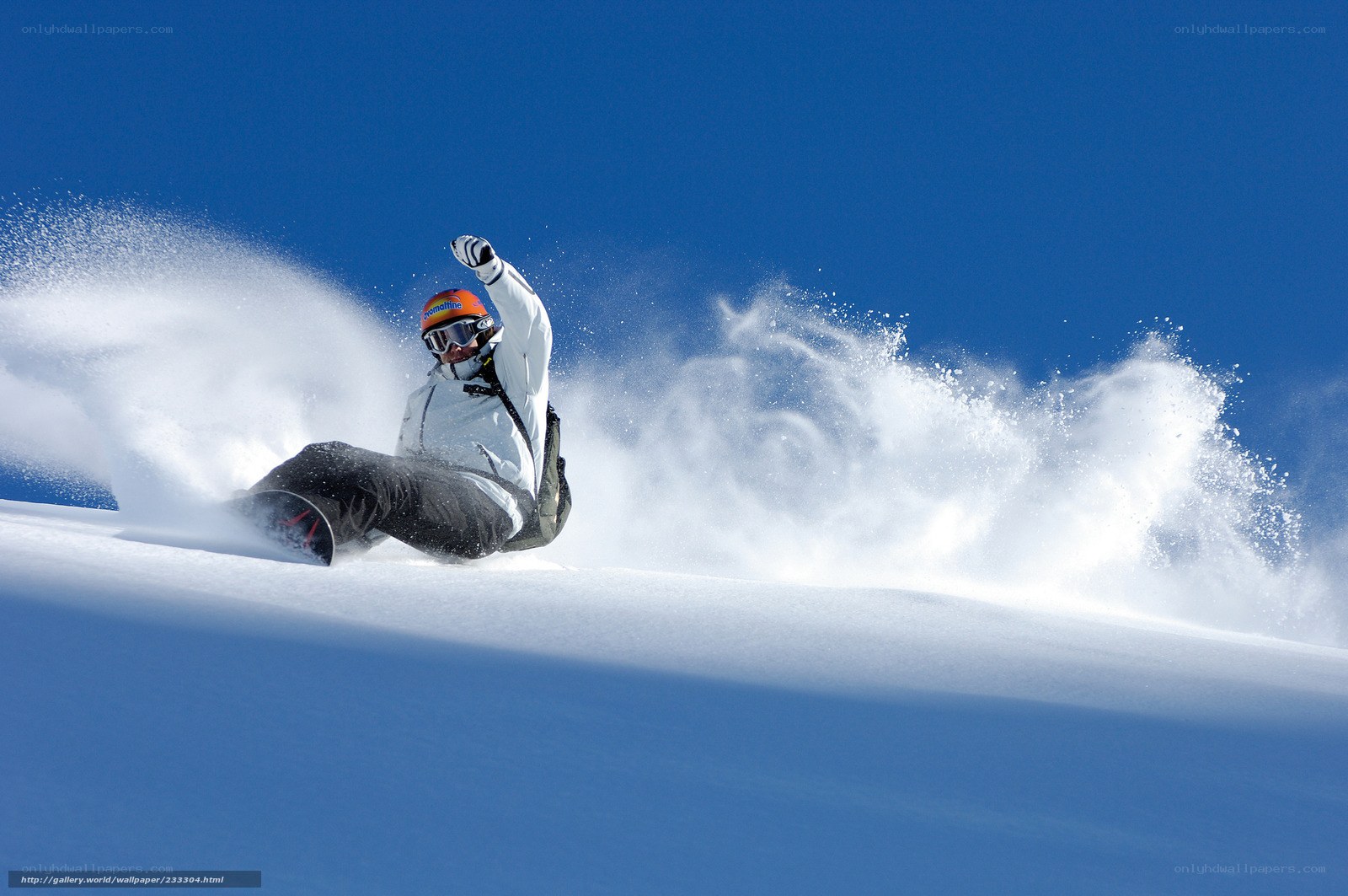 Snowboarder carving on a sunny day