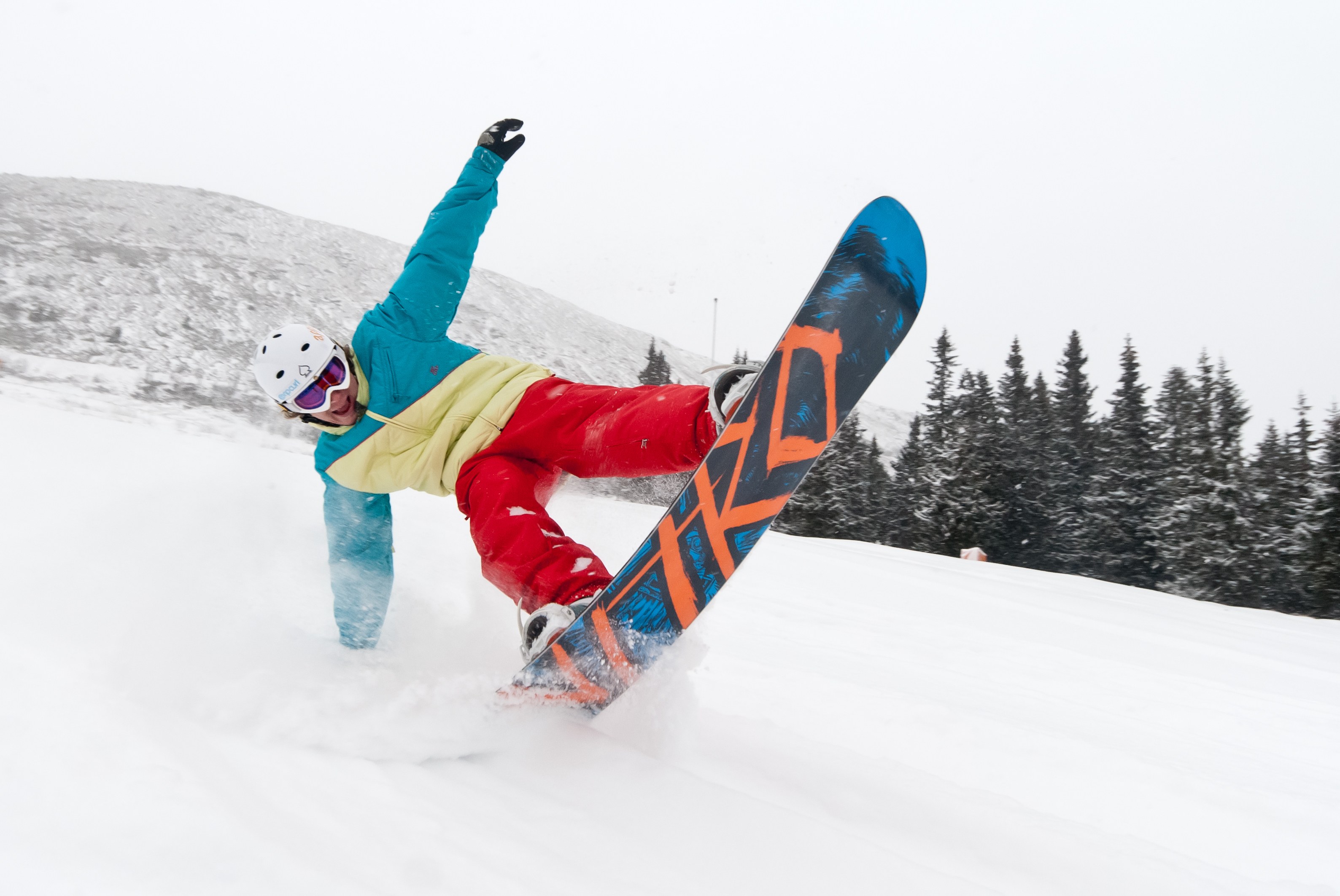 Snowboarder carving on slope