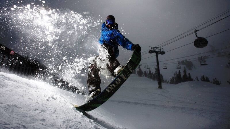 Snowboarder carving on snowy slope
