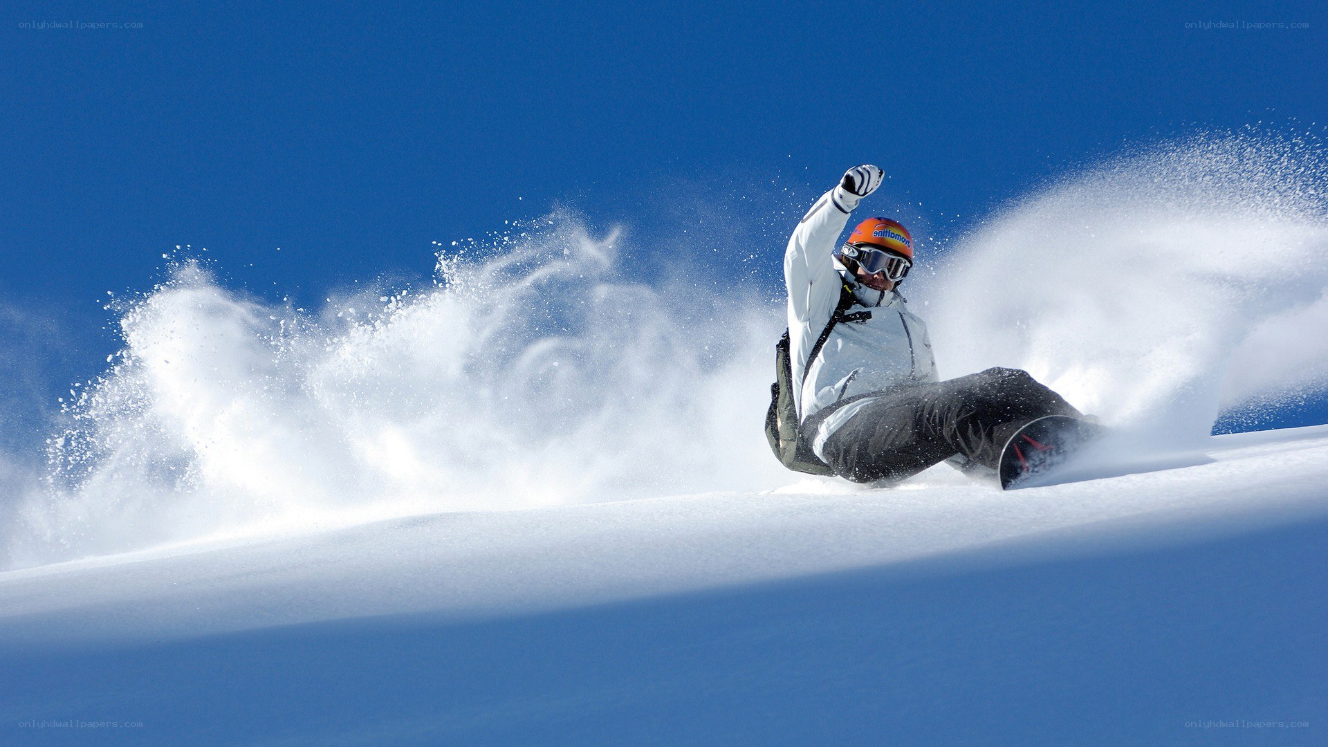 Snowboarder carving through powder