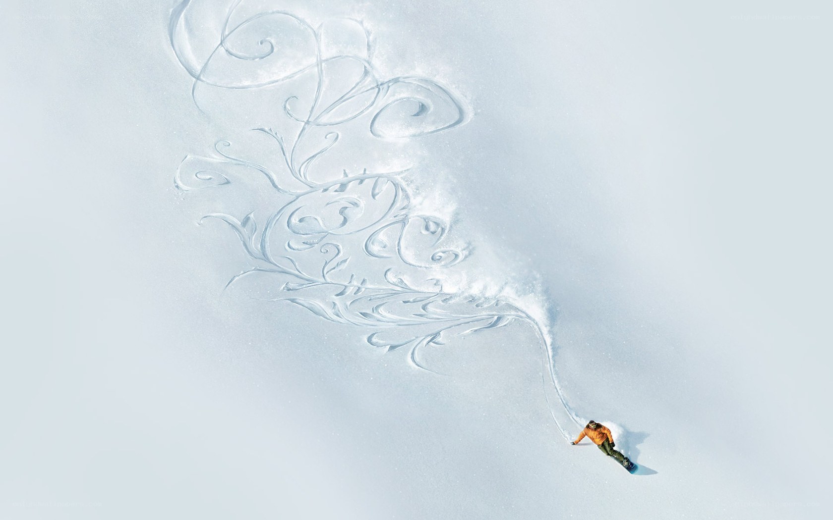 Snowboarder creating art in snow