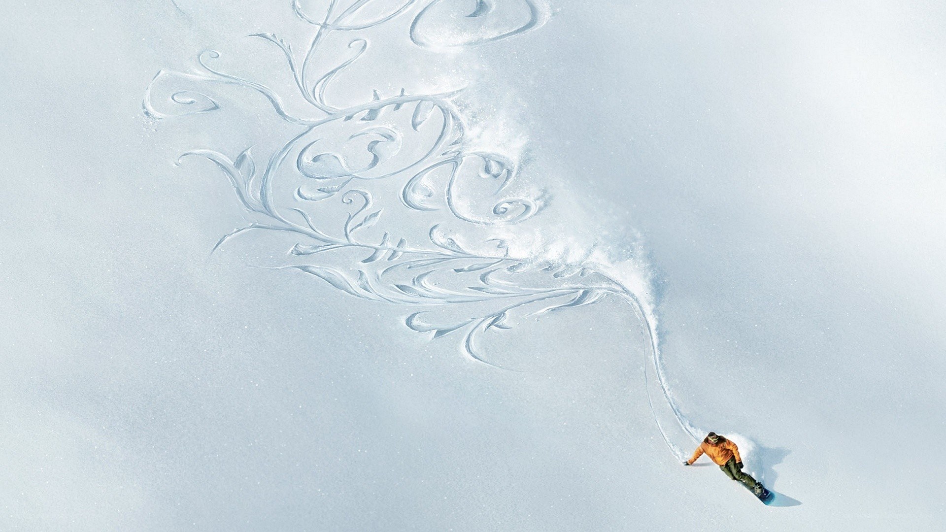Snowboarder creating art in snow