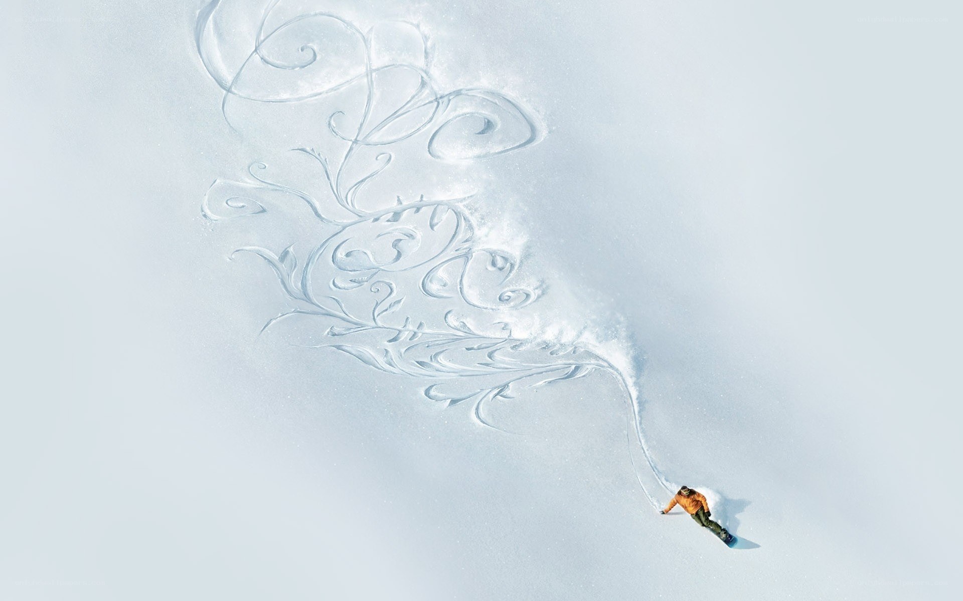 Snowboarder creating art in snow