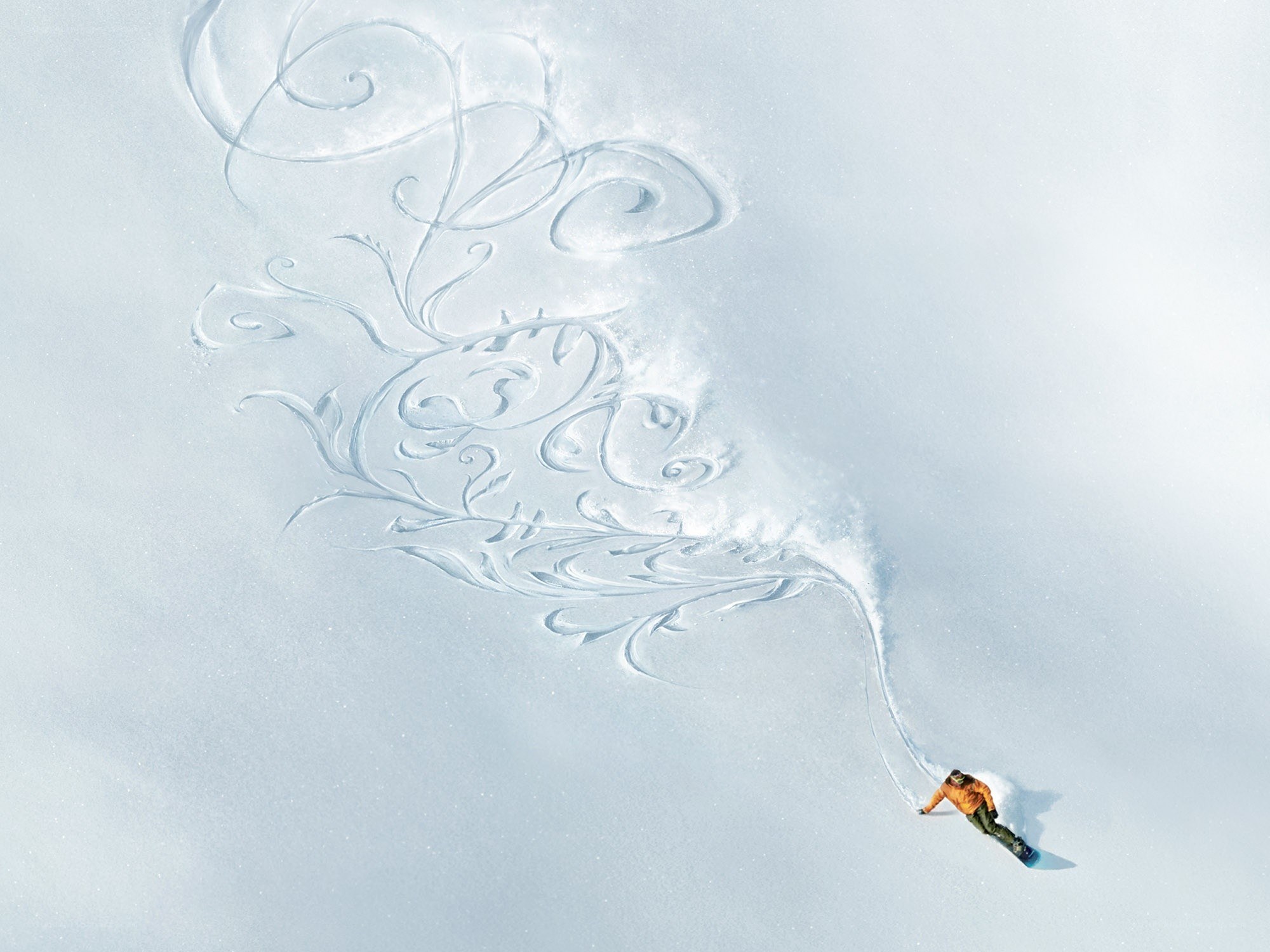 Snowboarder creating art in snow