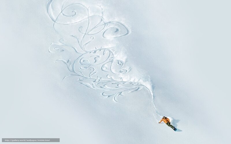 Snowboarder creating art in snow