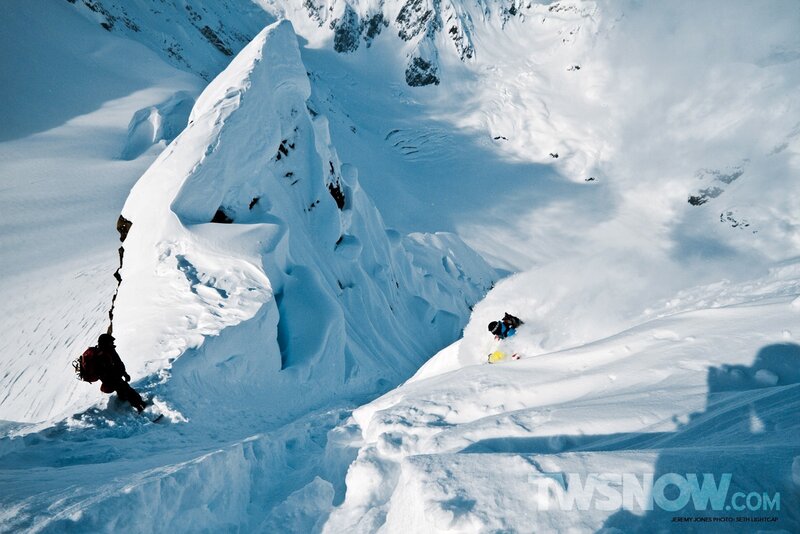 Snowboarder descending mountain