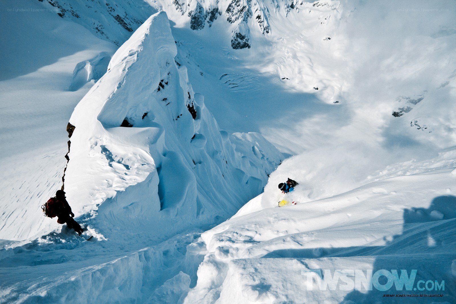 Snowboarder descending mountain
