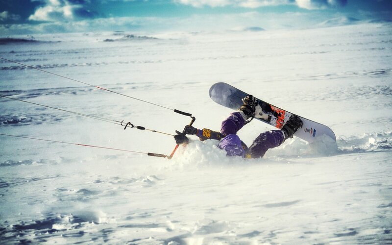 Snowboarder falling in snow