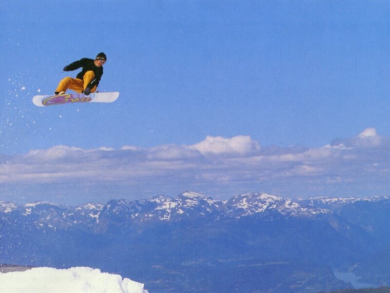 Snowboarder in Mid-air — Blue, Dynamic, Winter, Photograph, Mountains, Sky, Clouds, White, Yellow