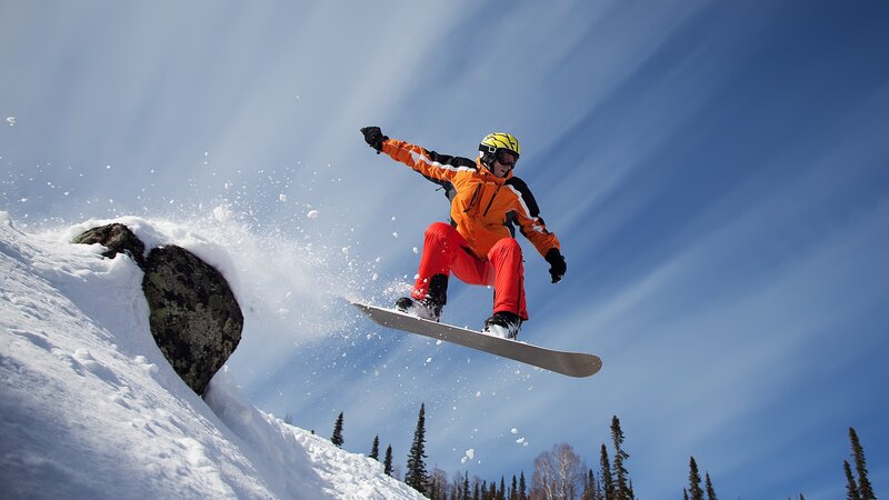 Snowboarder in Mid-air — Blue, Dynamic, Winter, Photograph, Snow, Sky, Trees, Rock