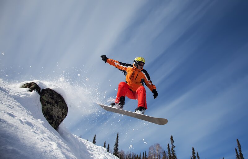 Snowboarder in Mid-air — Blue, Dynamic, Winter, Photograph, Snow, Sky, Trees, Rock, White