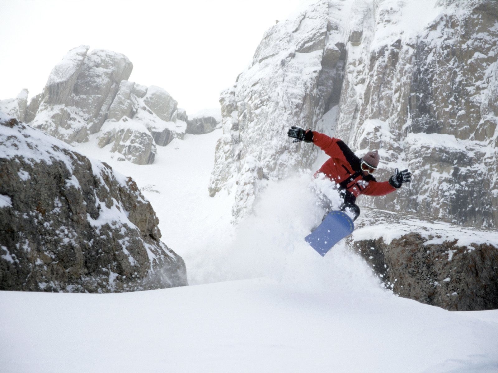 Snowboarder in mountain terrain