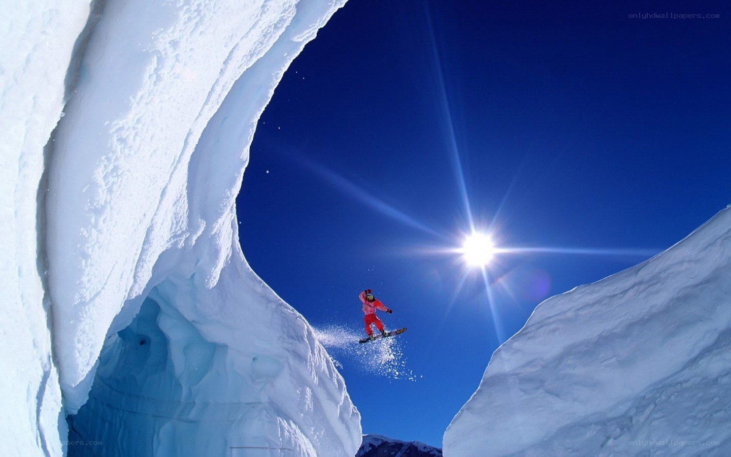 Snowboarder in snowy arch