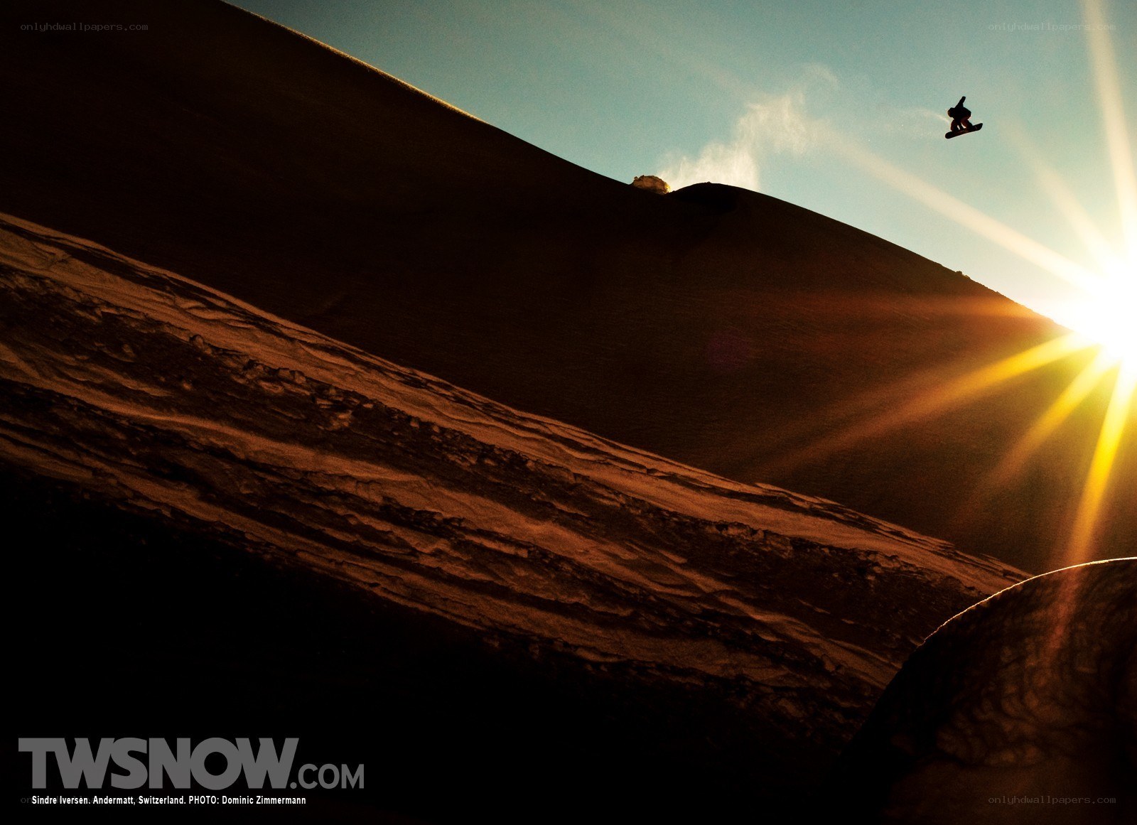 Snowboarder in sunset jump