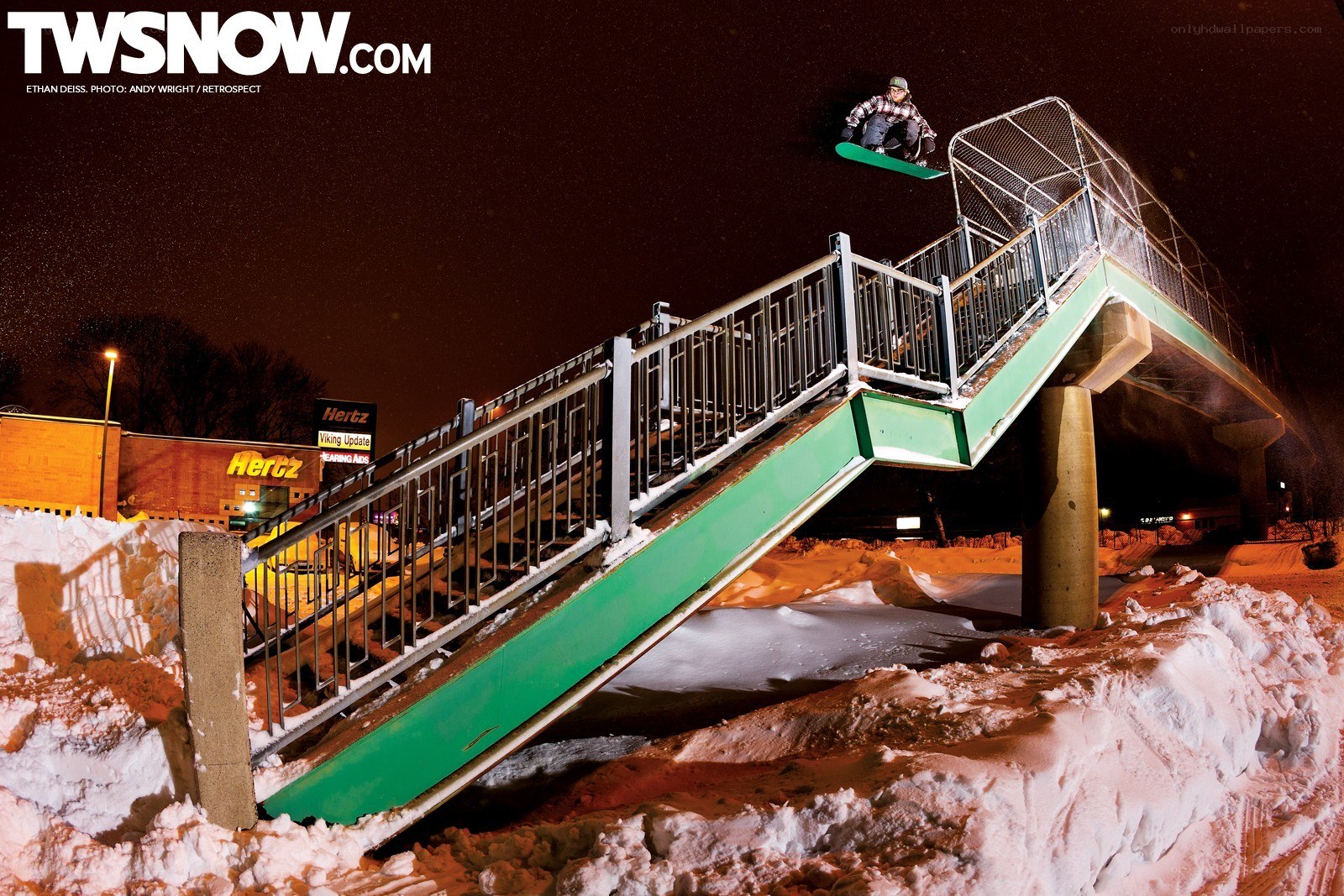 Snowboarder mid-air at night
