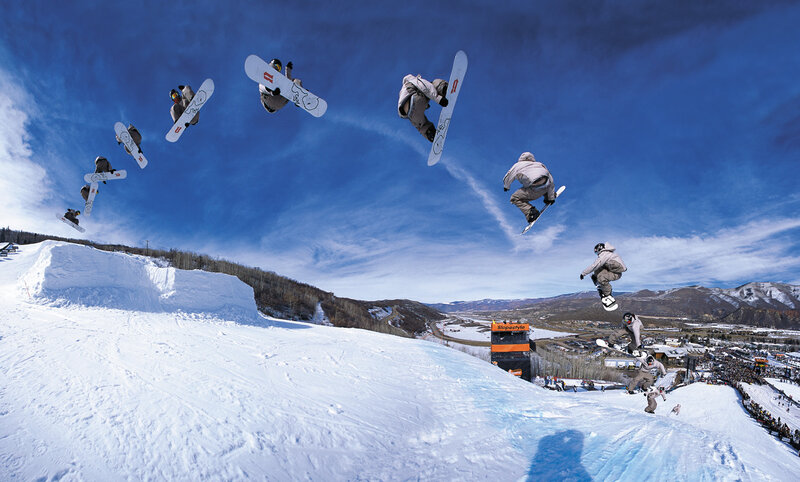 Snowboarder mid-air tricks