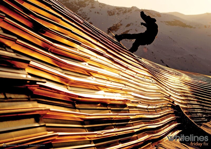 Snowboarder on a golden roof