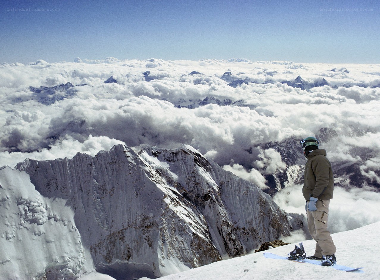 Snowboarder on a mountain peak