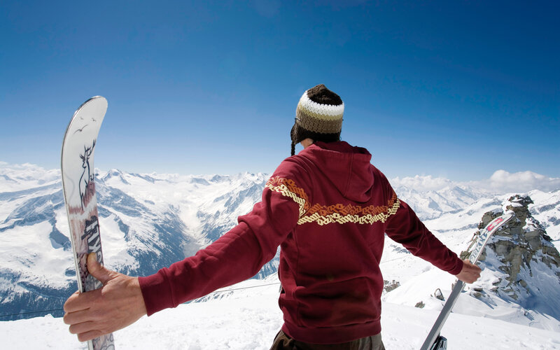Snowboarder on a mountain peak